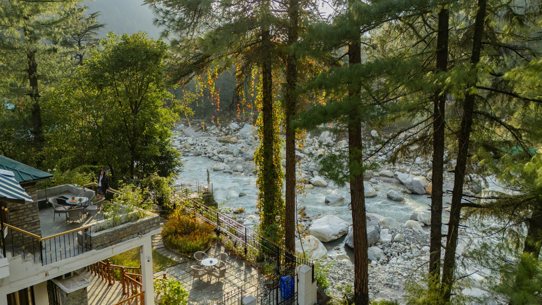 View from above the balcony toward the river and pines