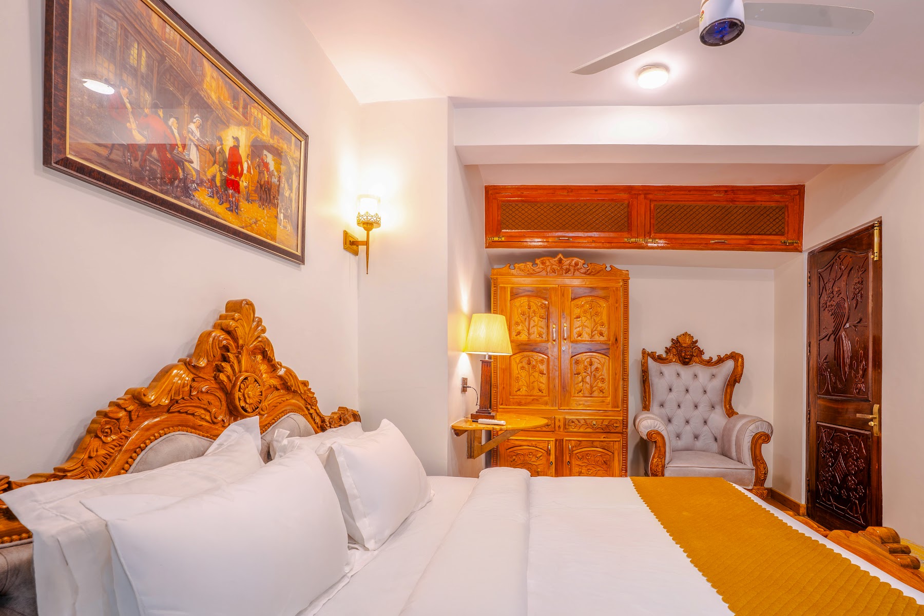 Bedroom with carved furniture in the Hall Balcony Suite