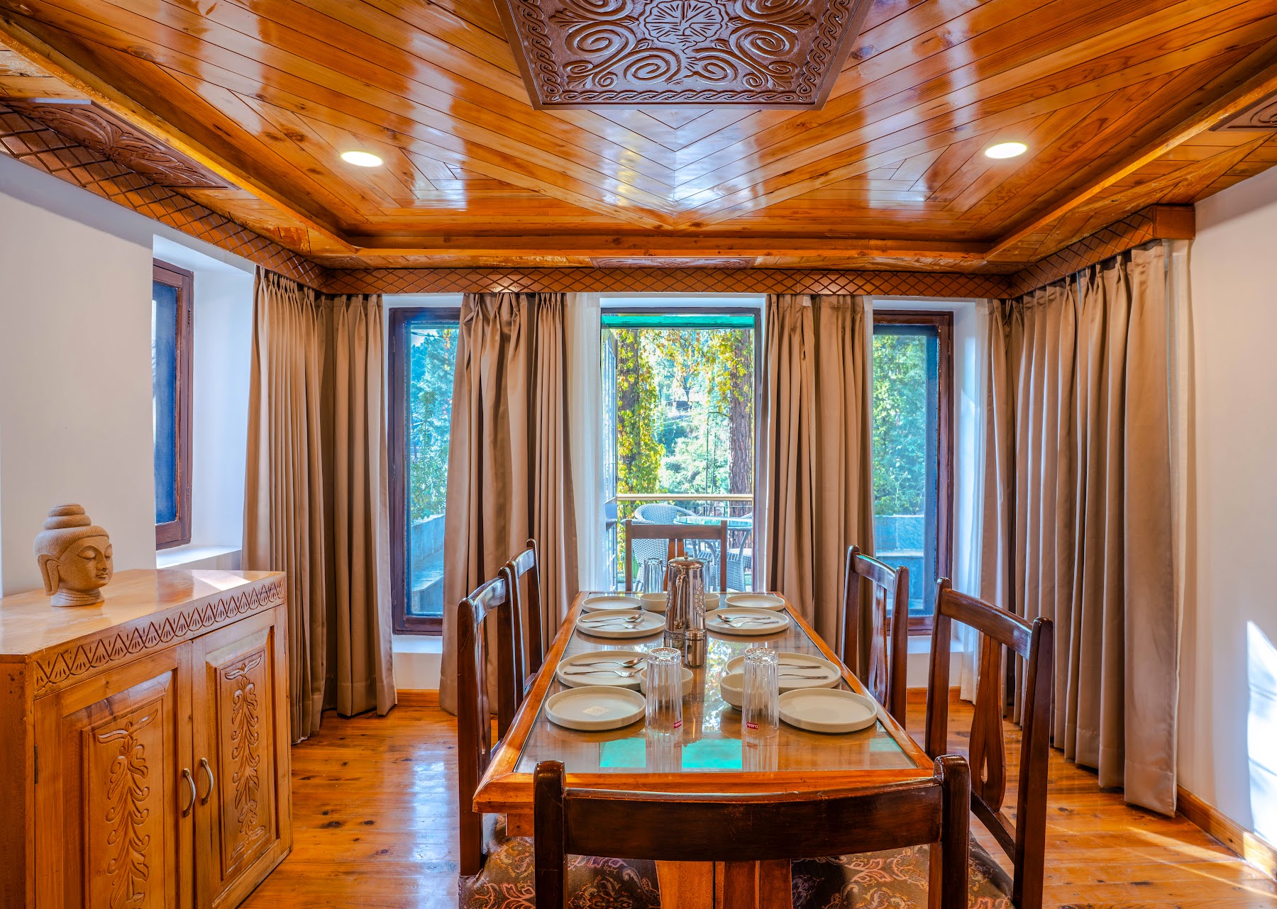Dining area with windows onto the forest