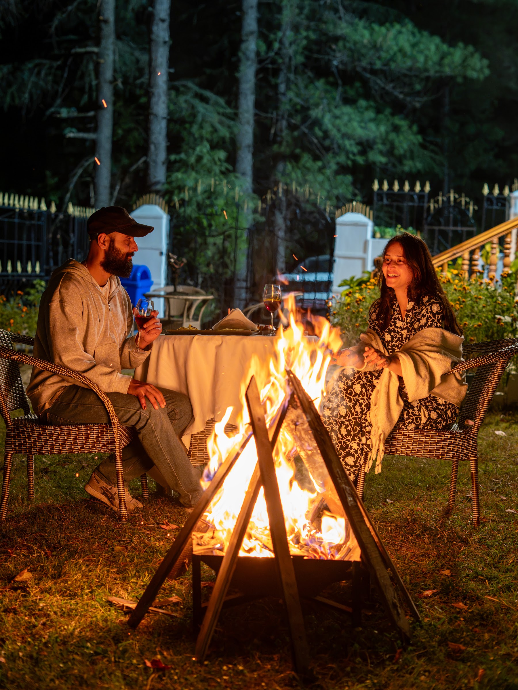 Guests seated around the bonfire at night