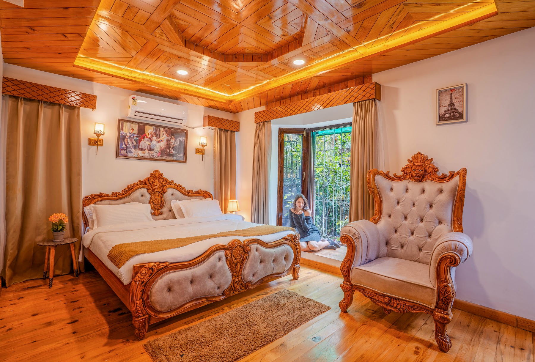 Carved wooden bed in a Courtyard Suite bedroom