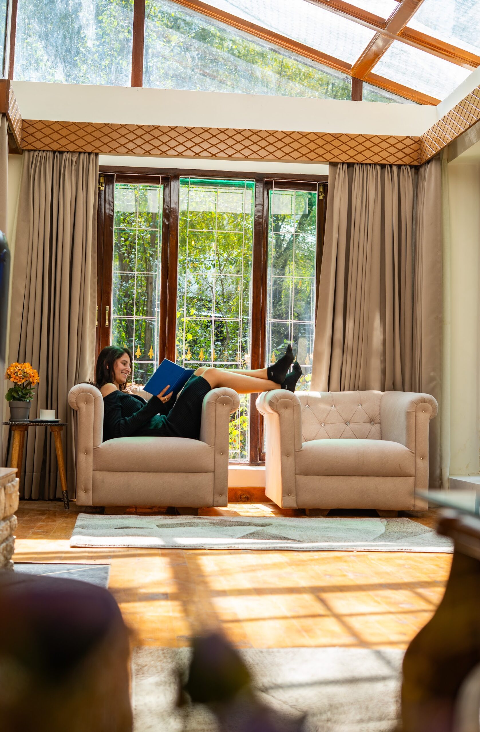 Armchairs in the glass-roofed living area of the Courtyard Suite