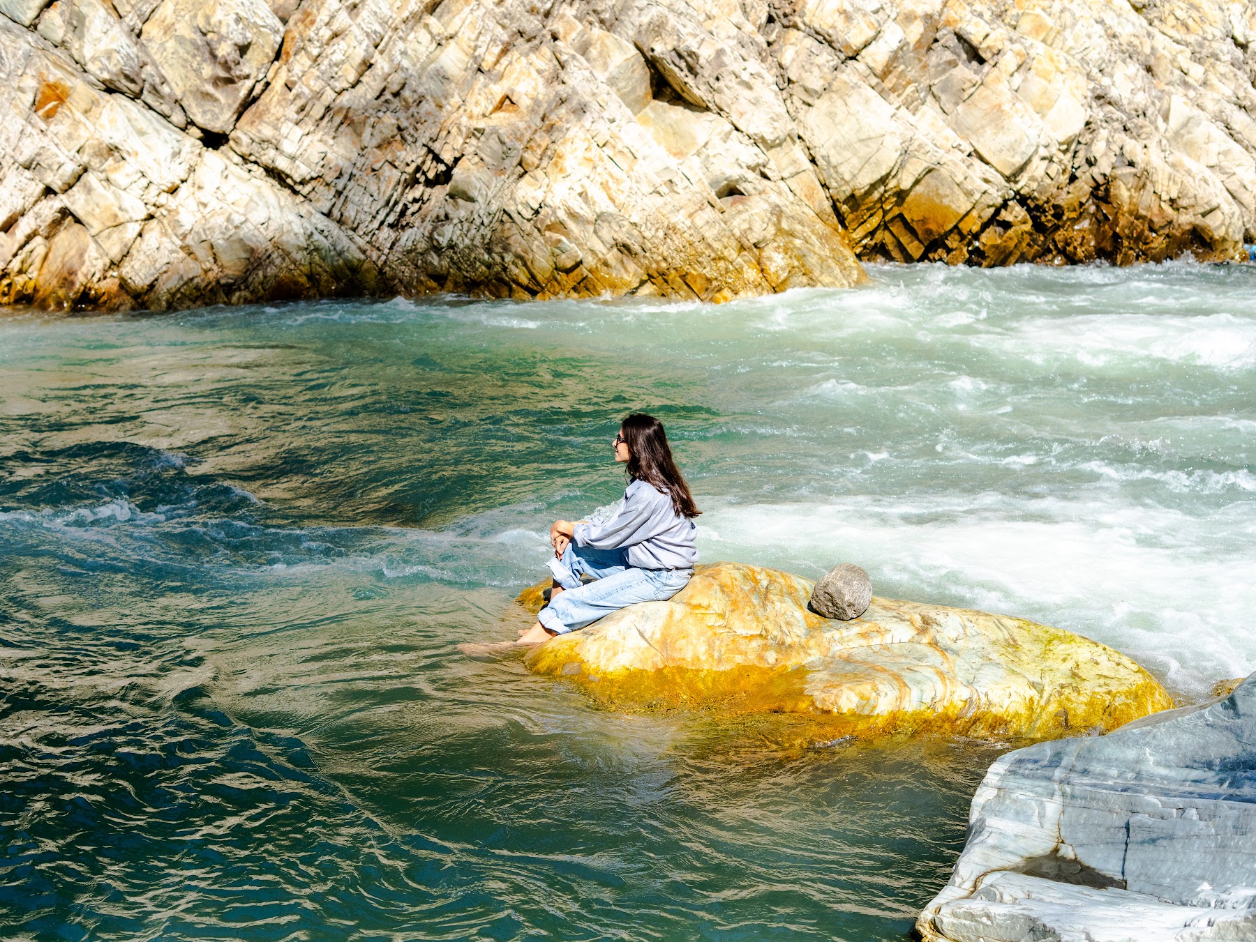 Clear water of the Parvati River among boulders