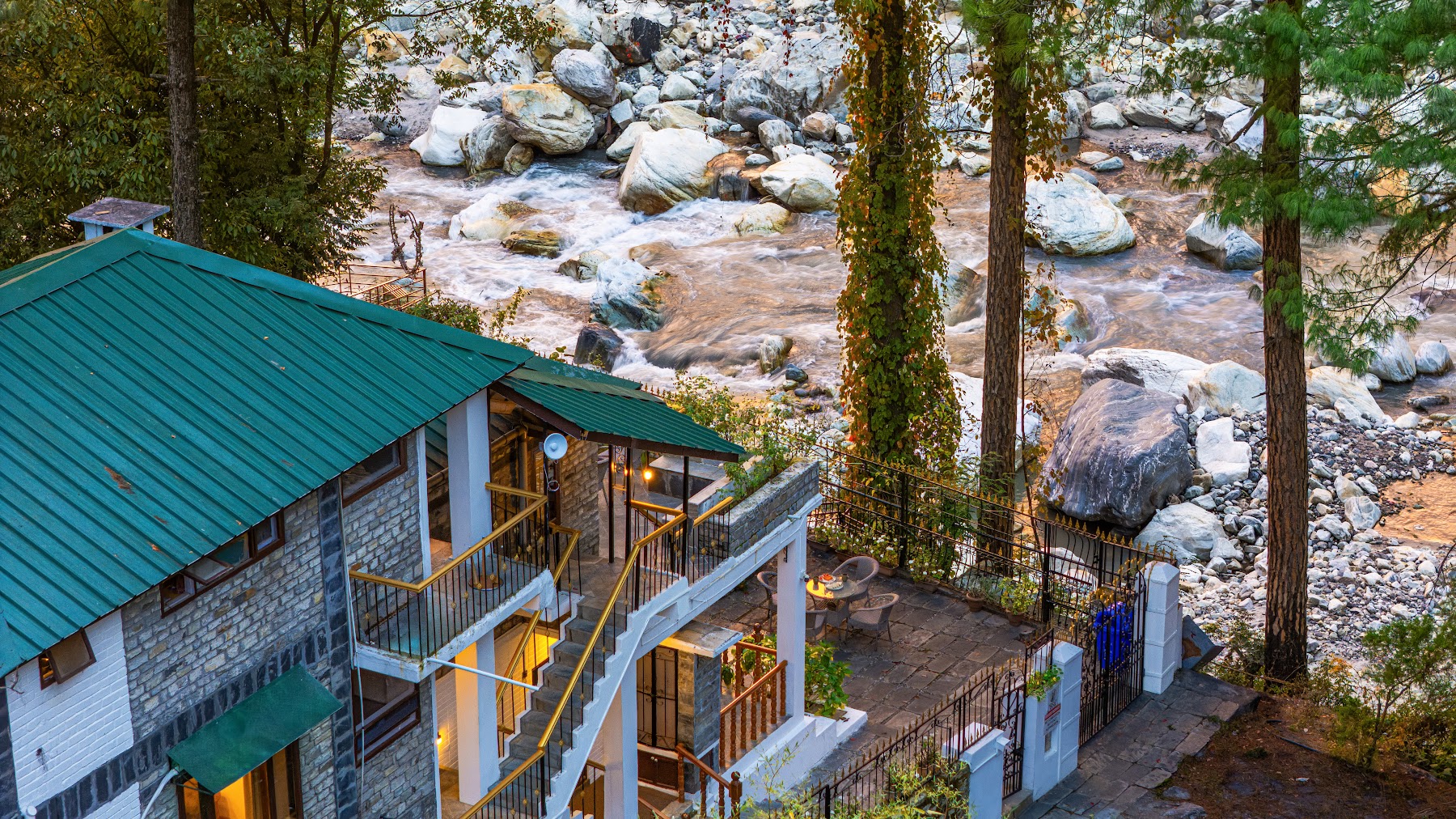 Aerial view of River Stone Villa beside the rocky Parvati River