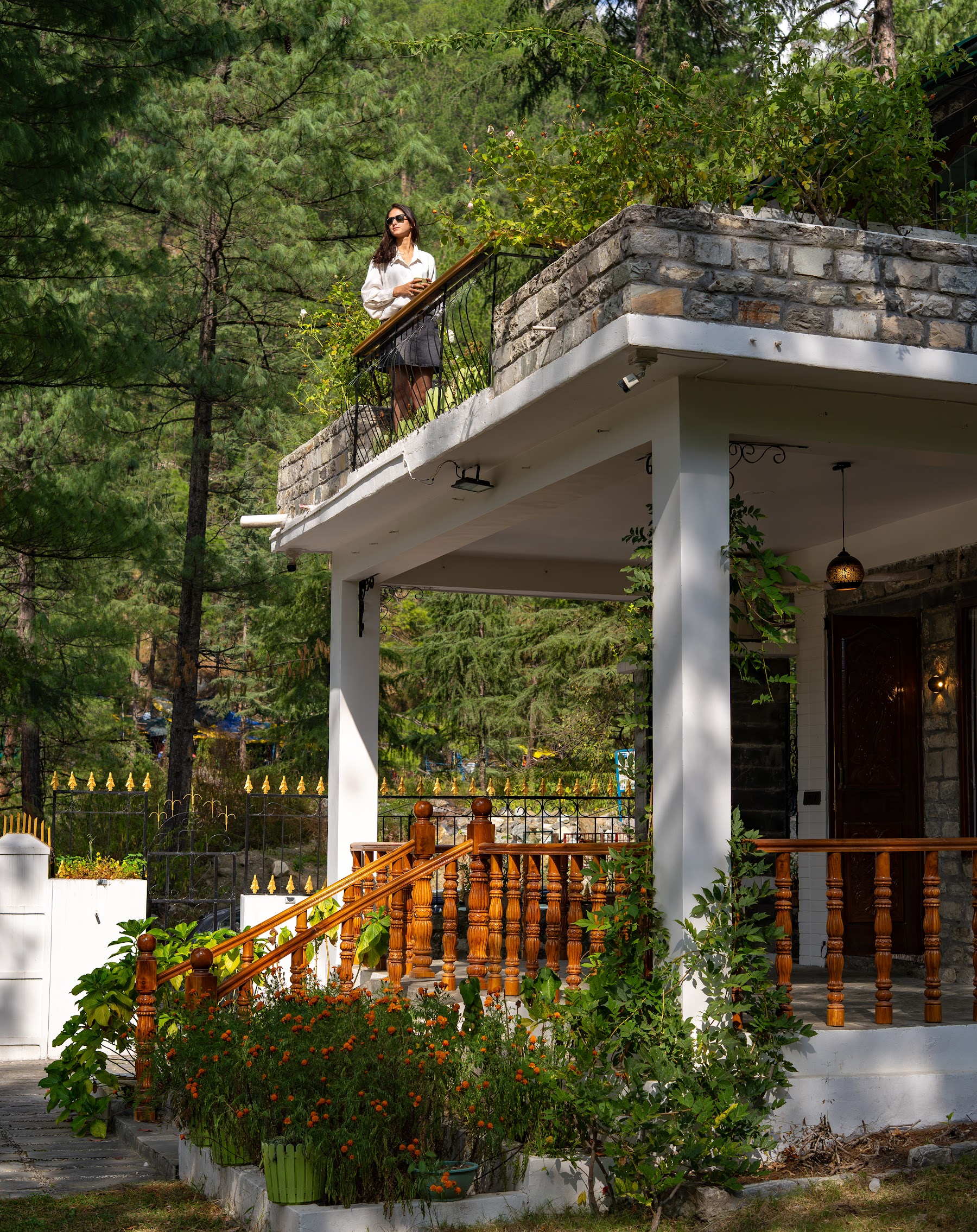 Guest on the upper balcony of River Stone Villa